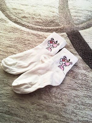 white pink panther socks on a carpet